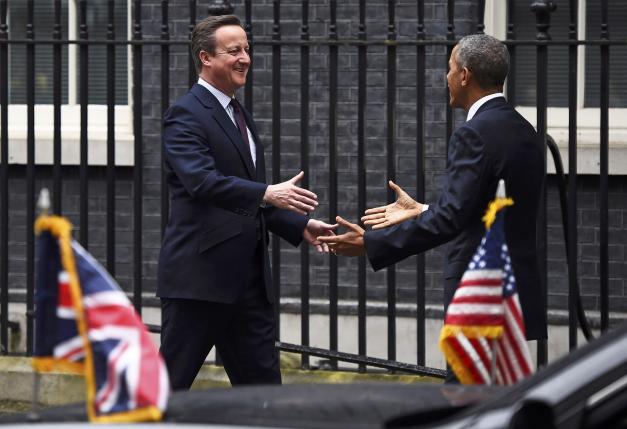 U.S. President Barack Obama is greeted by Britain's Prime Minister David Cameron at Number 10 Downing Street in London