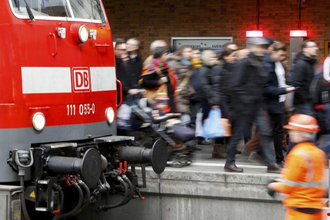 Passengers leave a train at the main train station in Munich