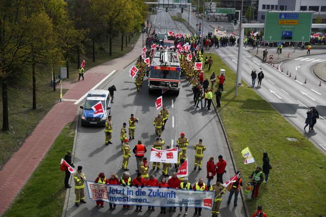 Firefighters, members of Verdi union, march during a strike near Frankfurt airport