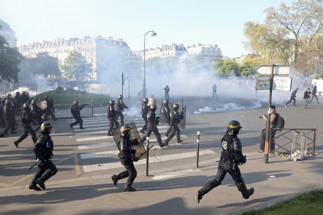 Clouds of tear gas fill the air at the Place de la Nation as French riot police advance on youths who protest against the French labour law proposal during the May Day labour union march in Paris