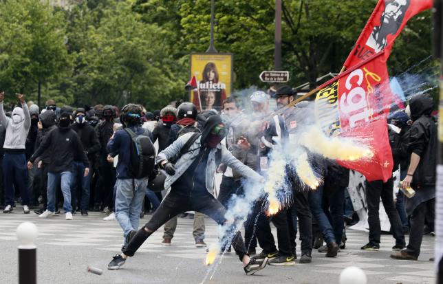 Protestors clash with riot police during a demonstration against French labour law reforms in Paris