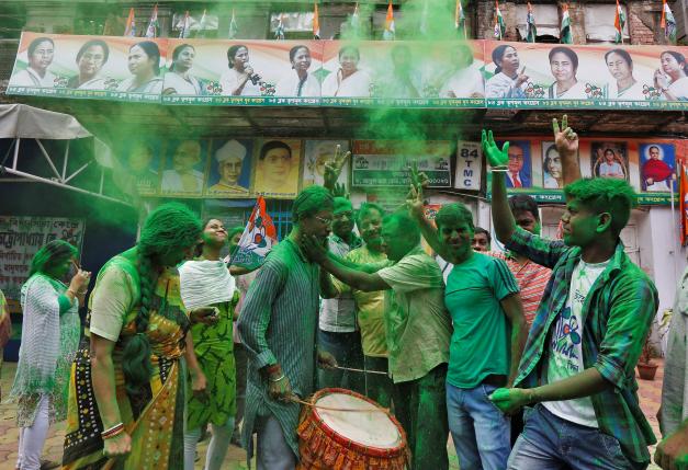 Supporters of TMC celebrate after learning the initial poll results of the West Bengal Assembly elections, in Kolkata