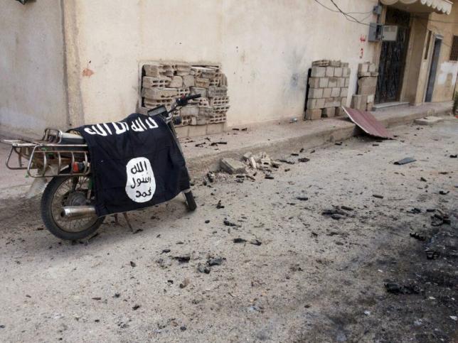 A flag belonging to the Islamic State fighters is seen on a motorbike after forces loyal to Assad recaptured the historic city of Palmyra