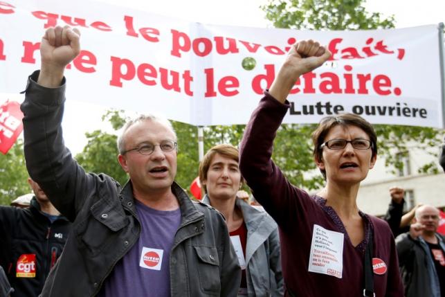 Jean-Pierre Mercier, CGT union representative and Nathalie Arthaud, France's extreme-left Lutte Ouvriere political party leader march during a demonstration in protest of the government's proposed labour law reforms in Paris