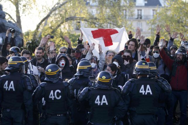French CRS riot police and youths face off at the Place de la Nation after protests against the French labour law proposal during the May Day labour union march in Paris
