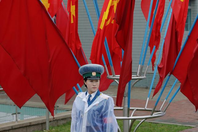A policewoman controls the traffic near the venue of the Workers' Party of Korea (WPK) congress in Pyongyang, North Korea