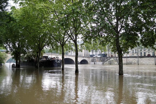 General view of the flooded river-side of the River Seine in central Paris with the 'Ile Saint-Louis' in the background