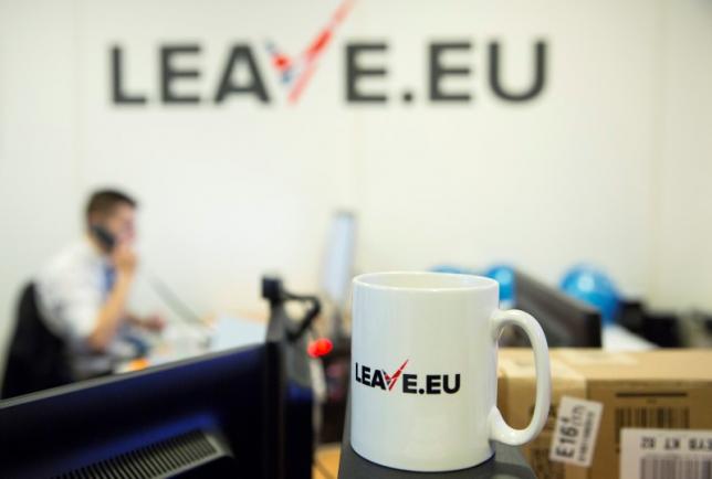 A worker answers a telephone in the office of Brexit group pressure group "Leave.eu" in London, Britain
