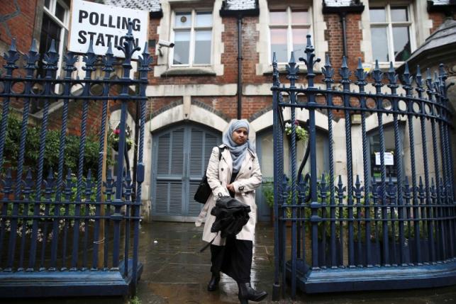 A woman leaves after to voting at a polling station for the Referendum on the European Union in north London