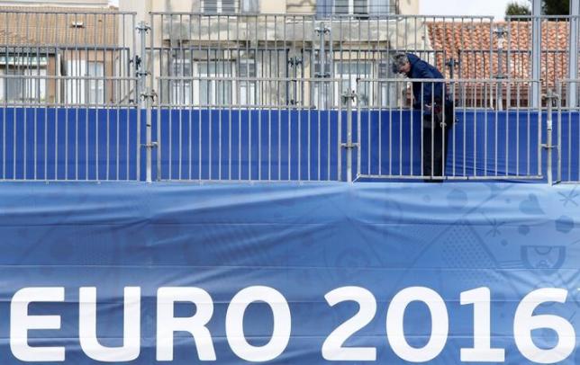 A worker installs safety barriers at a fan zone before the start of the UEFA 2016 European Championship in Marseille