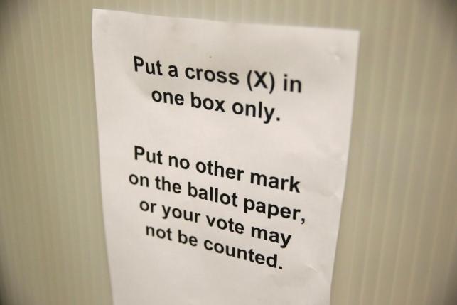 A sign gives voting instructions in a voting booth at a polling station for the Referendum on the European Union in north London