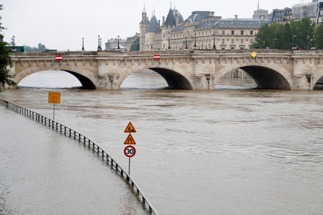 Road signs appear isolated in the rising waters from the Seine River as high waters causes flooding along the Seine River in Paris