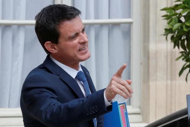French Prime Minister Manuel Valls leaves the Elysee Palace in Paris