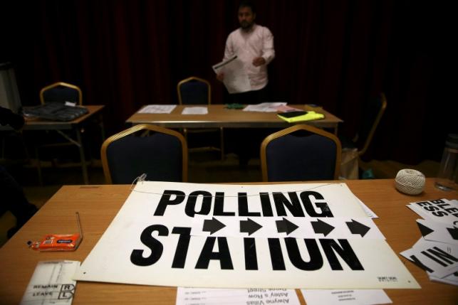 An electoral worker prepares a polling station for the Referendum on the European Union in north London
