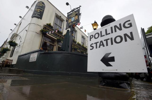 A sign points to a pub being used as a polling station for the Referendum on the European Union in west London