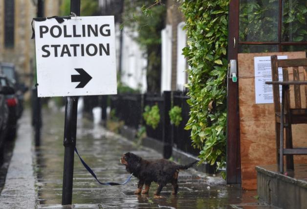 A dog waits for its owner outside a polling station for the Referendum on the European Union in west London