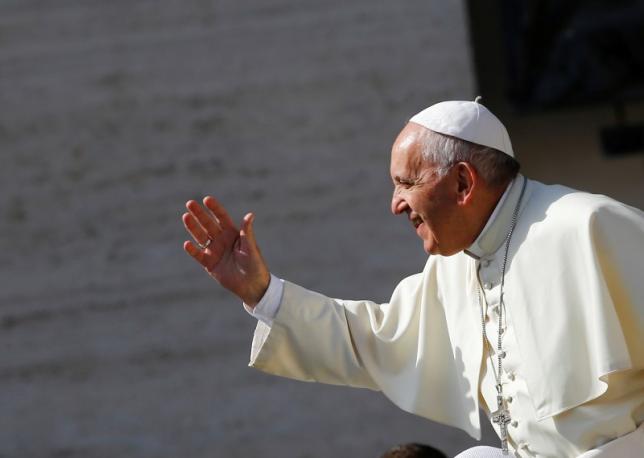 Pope Francis waves as he arrives to lead his Wednesday general audience in Saint Peter's square at the Vatican