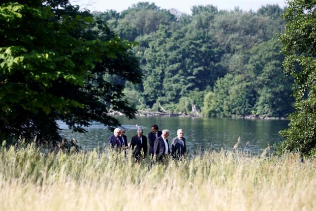 Ministers walk through the Park of the German Foreign Ministery guest house before a foreign minister meeting of the EU founding members in Berlin