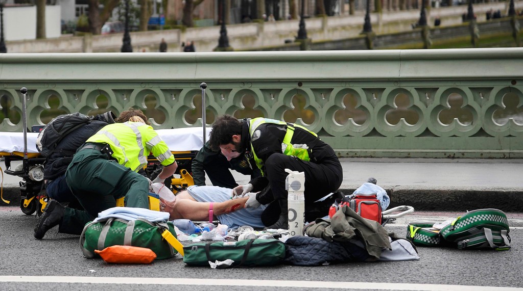 Paramedics treat an inured person after an incident on Westminster Bridge in London, March 22, 2017. REUTERS/Toby Melville